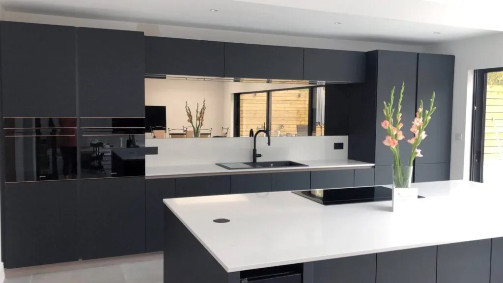 Dark grey kitchen with combination of natural wood and stone