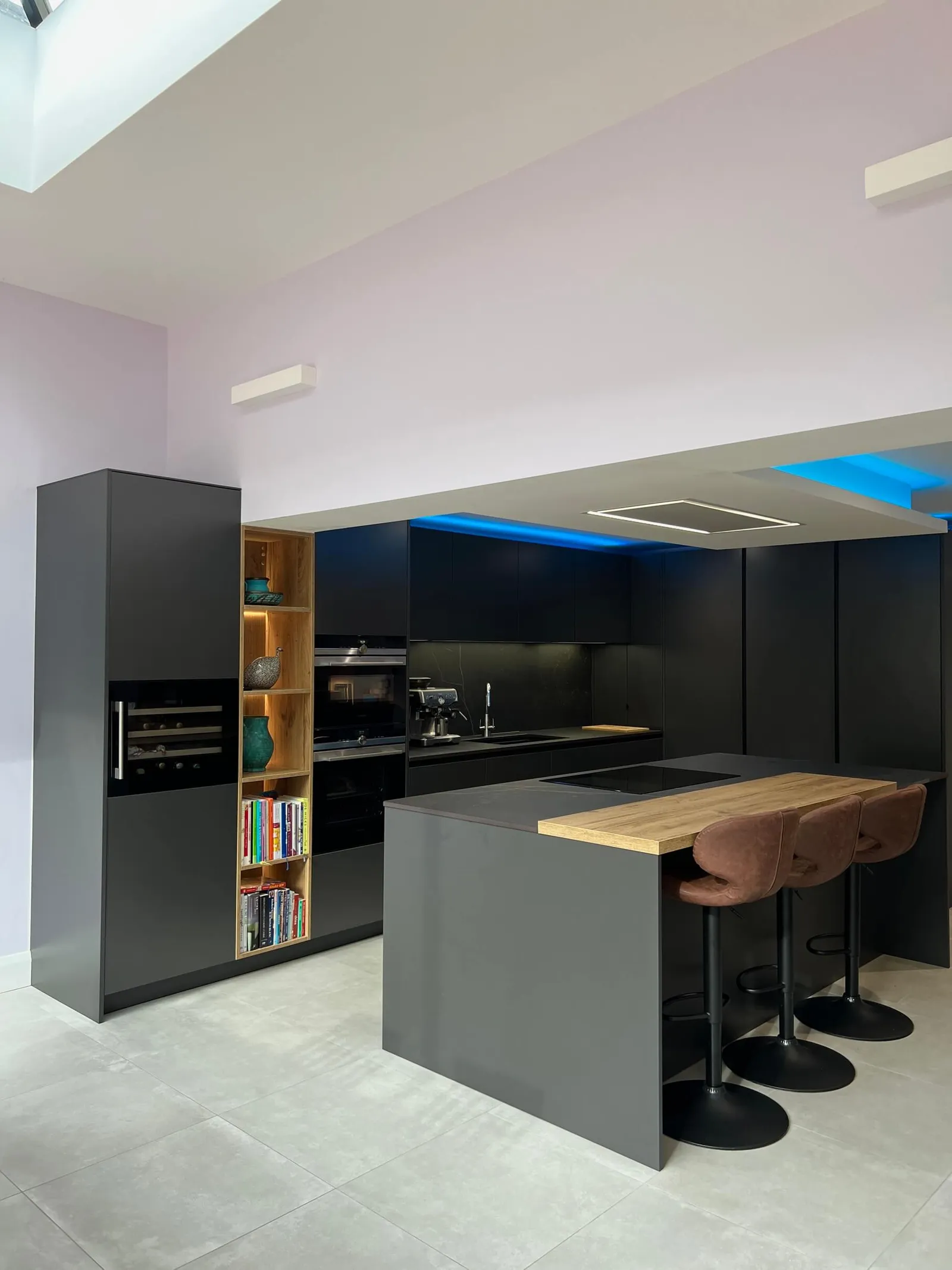Dark graphite kitchen with natural oak island worktop and illuminated shelving