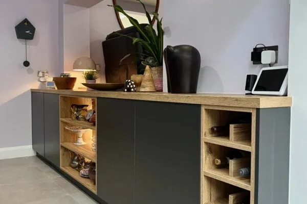 Dark grey kitchen with natural wood cabinetry and contrasting light worktops